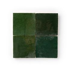 four square tiles with green and brown colors on each side, one in the middle