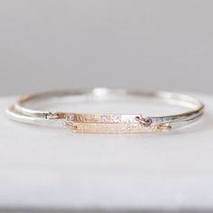 Sterling silver and 14k gold Diamond Bar Wildflower Bangle. The Gold bar has a hand-patterned wildflower garden with three sparkly white diamonds.  Details: *Gold bar - 1 1/4 L x 3.5mm W x 1.5mm thick Diamonds - 1.7mm Si1 white - Conflict-free Gold - 14k yellow - Eco-friendly, recycled Sterling Silver - Eco-friendly, recycled  Choose size at checkout.  *This items is Made-to-order. *Please see my shops home page announcement for current production time. https://www.etsy.com&#x2... Delicate Silver Diamond Bracelet In 14k Gold, Engraved White Gold Diamond Bracelet As A Gift, Engraved White Gold Diamond Bracelet For Gift, Engraved White Gold Diamond Bracelet Gift, Adjustable Silver Diamond Bracelet In 14k Gold, Adjustable Silver-colored 14k Gold Diamond Bracelet, Dainty White Gold Jewelry With Engraving Option, Sterling Silver Bangle With Diamond Accents As Gift, Sterling Silver Stackable Diamond Bracelet As Gift