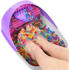 someone is playing with their toys in the bathtub while it's filled with beads