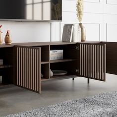 an entertainment center with books and vases on it