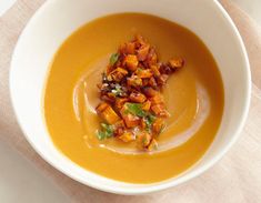 a white bowl filled with soup on top of a table