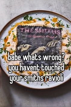 someone is holding up a plate with a cake on it that says, bae what's wrong? you haven touched your smith ravii