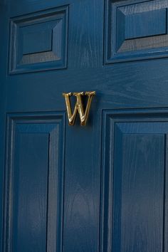 a blue door with a gold letter v on it