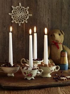 a teddy bear sitting next to some candles