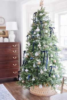 a decorated christmas tree with blue and white ornaments