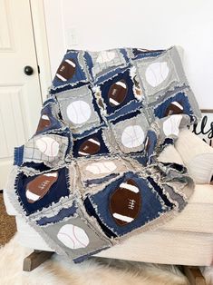 a couch with a baseball quilt on it and a teddy bear sitting next to it