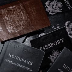 several different passports are sitting next to each other on a table with the word passport printed on it