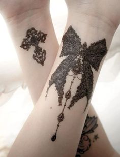 two tattoos that are on the arms of someone's legs and one has a cross