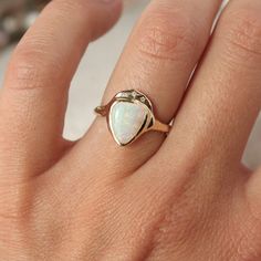 Front view of a white triangle opal is bezel set in 14k gold with three star set diamonds. Fine Jewelry 14k Gold Pear-shaped Opal Ring, 14k Gold Pear-shaped Opal Ring Fine Jewelry, 14k Gold Pear-shaped Opal Ring, Pear-shaped 14k Gold Opal Ring Fine Jewelry, Pear-shaped 14k Gold Opal Ring, 14k Yellow Gold Pear-shaped Opal Ring, Aurora Ring, Shield Ring, Ring Opal