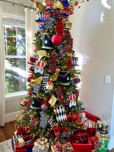 a christmas tree decorated with red, white and blue ribbons