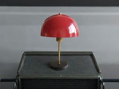 a red lamp sitting on top of a radio