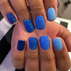 a person with blue nail polish on their nails