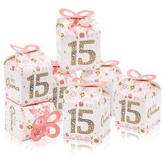 five pink and gold gift boxes with numbers on them, one is for fifteen and the other is for 15