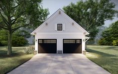 a white house with two black garage doors