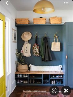 the entryway is decorated with baskets and coat racks