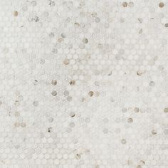 a white tiled wall with circles and dots