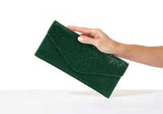 Adorned with meticulously placed crystal embellishments, our Classic Emerald Envelope crystal evening bag in a sleek envelope design adds a modern edge to its timeless beauty. Whether you are gracing a gala event or adding a touch of luxury to a romantic dinner, this clutch is a true gem that commands attention.    split  Crystal adorned classic handbag   Satin lined interior Signature magnetic snap closure Ebonized toned metal hardware Removable long shoulder chain Imported Dimensions: 10" L x 5" H  x .25" D Chain length: 40" / Handle drop 19" Style Number H225000 Gala Event, Crystal Clutch, Gala Events, Classic Handbags, Romantic Dinner, Envelope Design, Shoulder Chain, Romantic Dinners, Crystal Embellishment