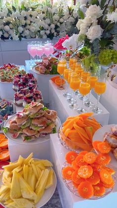 an assortment of food is on display at a wedding or brunch buffet table