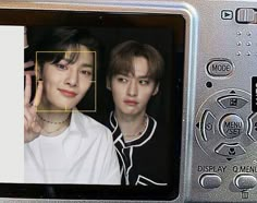 two people are shown on the screen of a digital camera