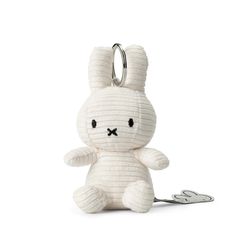 a white stuffed animal keychain with a black nose