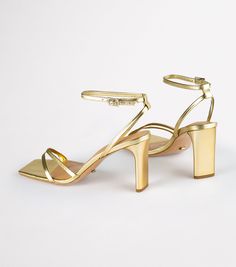 Complete your party look with our Corso strappy heels in gold nappa. Designed with slender foot-framing straps, an adjustable and secure ankle strap, and is finished with a mid-height stiletto heel. -Material: Leather Upper & Lining -Sole: Rubber -Fit: True to size -Toe-shape: Squared toe-shape -Heel: 8.5cm stiletto heel Shop Heels, Thigh High Boots Flat, Embellished Heels, Heels Online, Metallic Shoes, Bridal Heels, Tony Bianco, Metallic Heels, Bow Heels