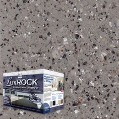 a box sitting on top of a cement floor covered in rocks and glass shards with the lid open