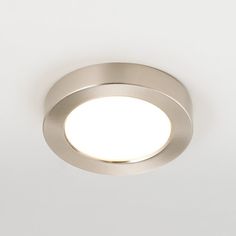 a close up of a light on a white wall with no lighting in it,