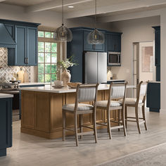 a kitchen with blue cabinets and white counter tops, an island in the middle is surrounded by four chairs