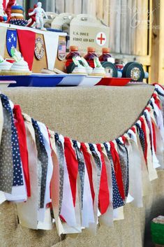 an american flag bunting is hanging from the side of a table