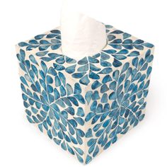 a tissue paper dispenser with blue leaves on it