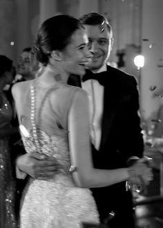 black and white photograph of a bride and groom hugging at the end of their dance