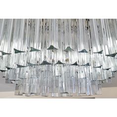 a chandelier made out of glass rods and some birds on the bottom one