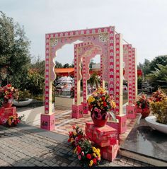 a pink and white structure with flowers in it