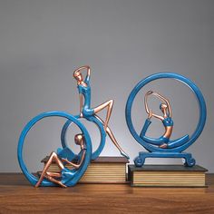 a blue sculpture sitting on top of a wooden table next to a stack of books