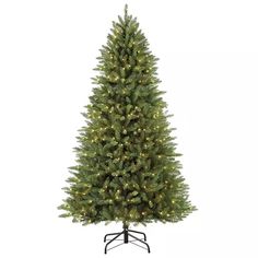 a green christmas tree with white lights on the top and black stand against a white background