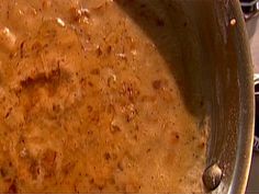 a pan filled with food sitting on top of a stove