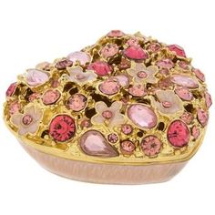 Dimensions: 1" H x 2.13" W x 1.94" D Material: Metal & Enamel Color: Light Pink, Pink, Purple & Gold Quantity: 1 Bring a delightful accent to your vanity with this Pink Floral Heart Rhinestone Jewelry Box. This ornately decorated box has a magnetic closure and comes in the shape of a heart with a brilliant display of rhinestones and flowers across the top. Cutouts between some of the flowers and rhinestones allow you to see inside when the lid is closed. Hold your favorite rings, earrings, or a Heart Jewelry Box, Small Container, Heart Rhinestone, Floral Heart, Fabric Bolts, Rhinestone Heart, Delicate Jewelry, Rhinestone Jewelry, Pink Rhinestones