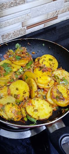 a frying pan filled with lots of food on top of a stove burner