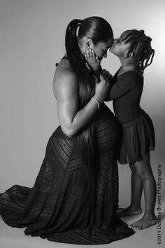 two women are kissing each other in black and white