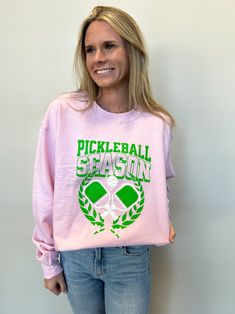 Express your love and excitement for the fastest growing sport in the US, PICKLEBALL, With this cozy crewneck sweatshirt!! We are in love with this sweatshirt and we know you will be too! She is super soft and perfect for an occasion including a early spring night on the courts! Grab your now I don't think this on will last! * Fits True to size Collegiate Graphic Print Sweatshirt For Spring, Varsity Crew Neck Sweatshirt For Spring, Spring Crew Neck Sweatshirt For Sports, Collegiate Style Long Sleeve Spring Sweatshirt, Sports Season Crew Neck Sweatshirt With Screen Print, Sports Sweatshirt With Screen Print, Long Sleeve, Pink Sporty Sweatshirt With Screen Print, Sporty Pink Sweatshirt With Screen Print, Sporty Long Sleeve Screen Print Sweatshirt