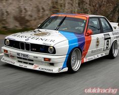 a white and blue car driving down a road