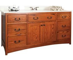 a bathroom vanity with two sinks and wooden cabinetry on the top, against a white background