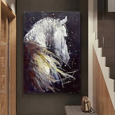 a white horse painting hanging on the wall next to a brown bench in a hallway