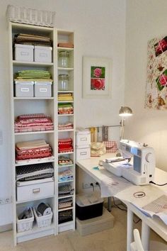 a sewing machine sitting on top of a table next to a shelf filled with fabric