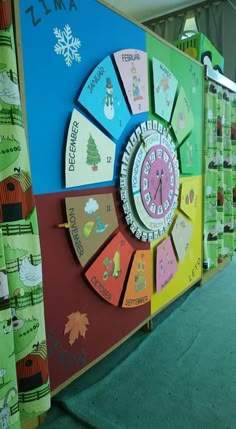 a brightly colored wall with a clock in the center and snowflakes on it