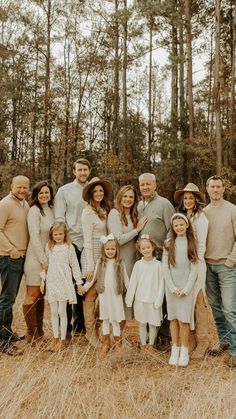 a large family posing for a photo in the woods