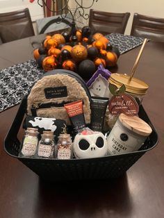 a basket filled with halloween items on top of a wooden table