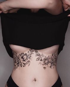 a woman's stomach with flowers on it and the bottom part of her body