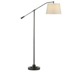 a floor lamp with a white shade on top and a black base, in front of a