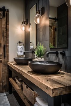 a bathroom with two sinks and mirrors in it's dark wood cabinetry, along with hanging lights